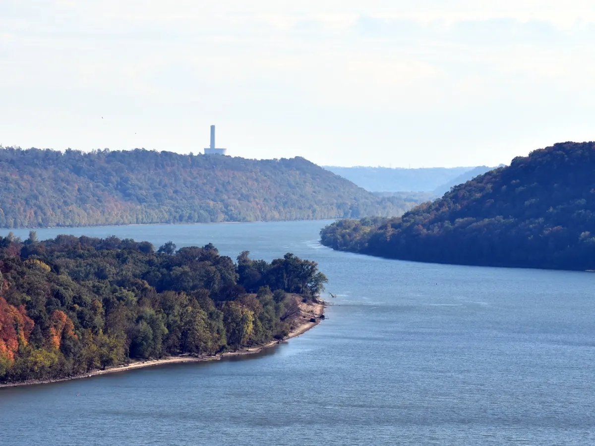 a large body of water with a mountain in the background