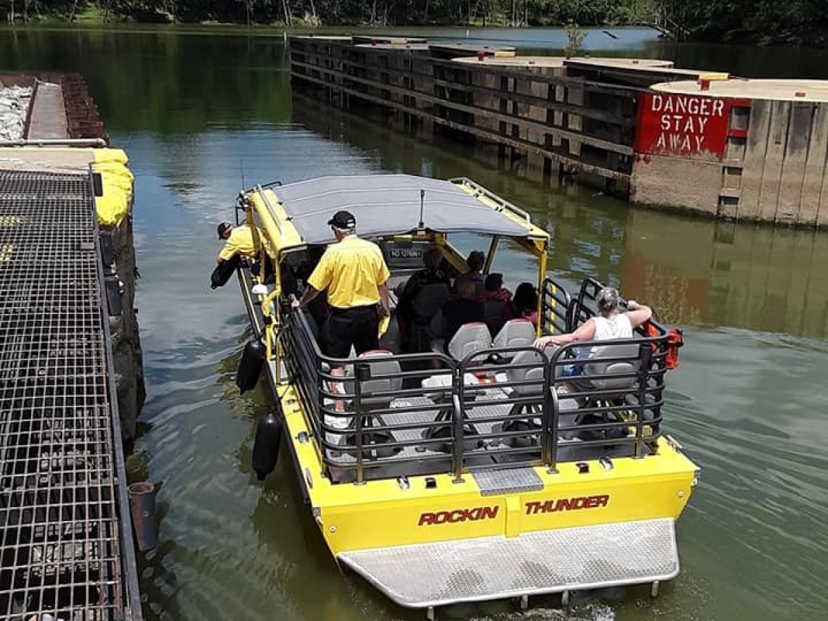 a group of people in a boat on a body of water