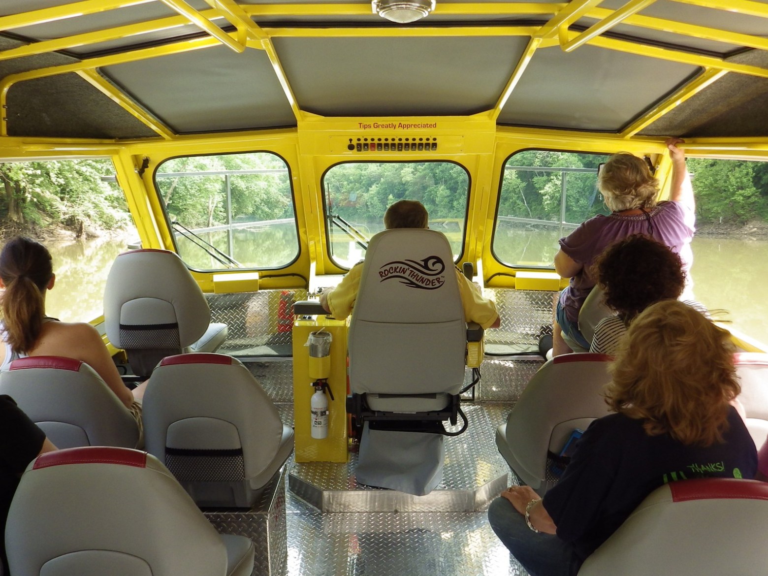 a group of people sitting around a car
